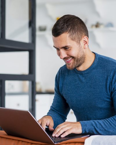 smiley-man-working-laptop-from-home